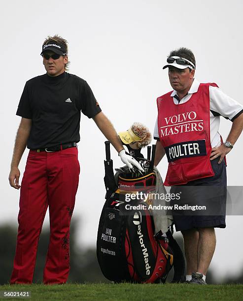 Ian Poulter of England waits with his caddy Mick Donaghy on the 17th hole during the first round of The Volvo Masters on October 26 2005 at...