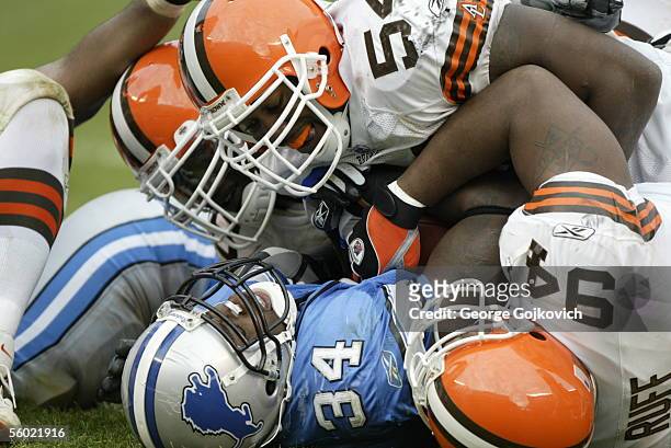 Linebackers Andra Davis and Orlando Ruff of the Cleveland Browns and other Browns tackle running back Kevin Jones of the Detroit Lions at Cleveland...