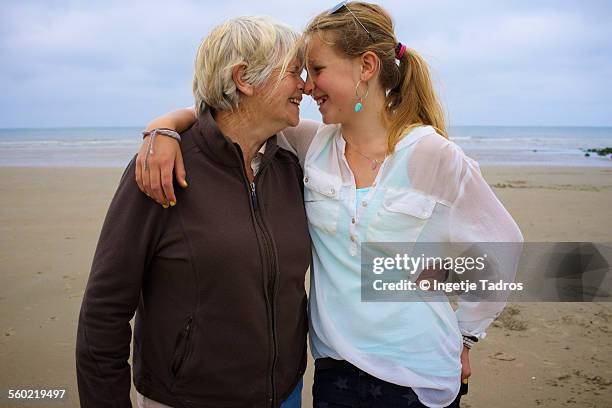 grandmother and granddaughter on the beach - vlieland stock pictures, royalty-free photos & images