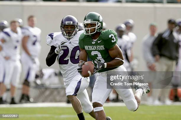 Wide receiver Kyle Brown of the Michigan State Spartans carries the ball against cornerback Marquice Cole of the Northwestern Wildcats at Spartan...