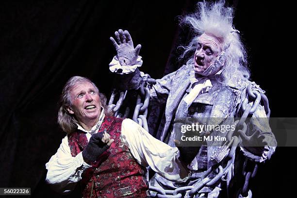 Actors Tommy Steele and Barry Howard pose at a photocall to promote his role as Ebenezer Scrooge in the new stage version of "Scrooge" at the London...