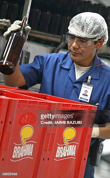 Un trabajador guarda en cajones botellas de cerveza de la marca brasilena Brahma en Lima, el 27 de octubre de 2005, durante la inauguracion de...