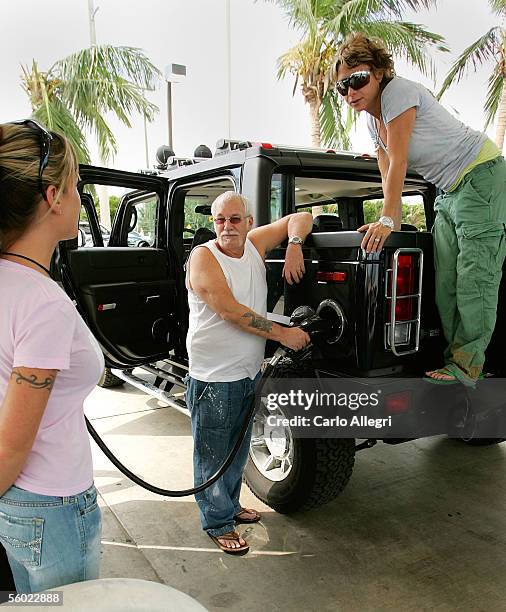 Marc Shaffman and his wife, Michelle Shaffman , fill up their Hummer with gas after waiting in line October 27, 2005 in Miami, Florida. Hurricane...