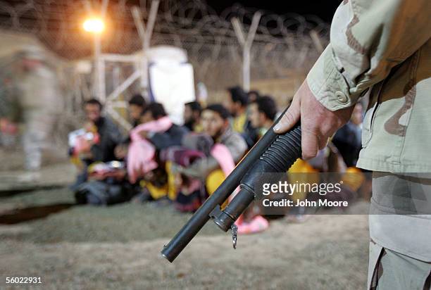 New arrivals are guarded while being processed into the Abu Ghraib Prison facility October 27, 2005 which is located on the outskirts of Baghdad,...