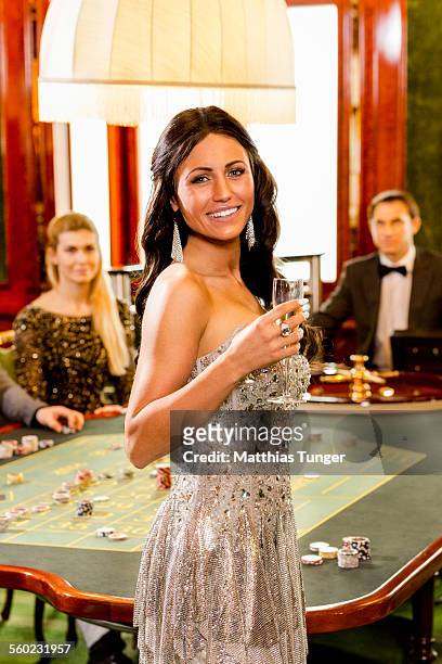 young woman smiling in a casino - silver dress foto e immagini stock