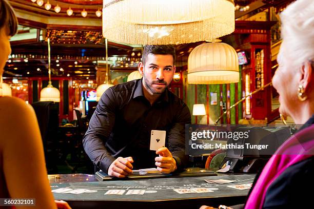 playing blackjack in a casino - casino worker ストックフォトと画像