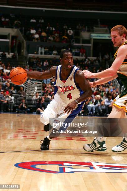 Anthony Goldwire of the Los Angeles Clippers handles the ball against Robert Swift of the Seattle SuperSonics during the NBA preseason game on...
