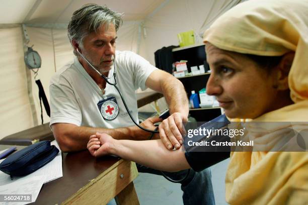 German doctor Richard Munz treats a patient at the Basic Health Care of the German Red Cross October 25, 2005 in Muzaffarabad, Pakistan controlled...
