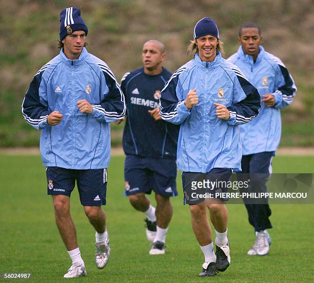 Real Madrid's Guti runs with Paco Pavon , followed by Brazilians Roberto Carlos and Robinho during the club's training session in Las Rozas near...