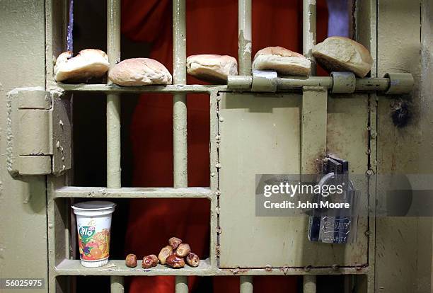 Rejected by an Iraqi prisoner, bread and dates await removal from the door of a solitary confinement cell in the Iraqi-government-run criminal...