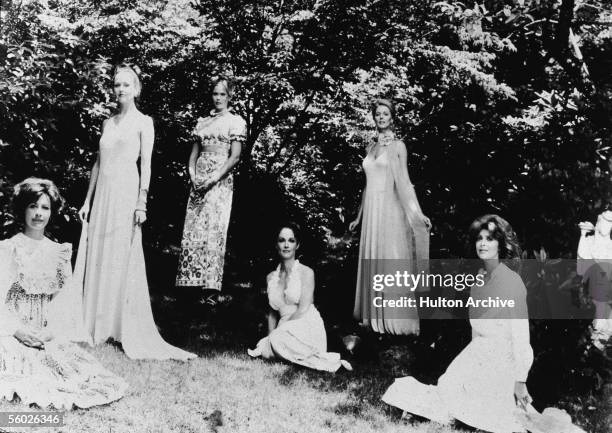 The female cast members of the horror film 'The Stepford Wives' pose for a promotional picture outdoors wearing long, flowing dresses, 1975. The...