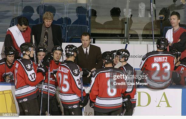 Head coach Kevin Dineen of the Portland Pirates talks to players at the bench during a break in the game against the Bridgeport Sound Tigers at the...