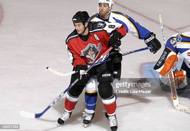 Tim Brent of the Portland Pirates battles for position in the slot against Vince Macri of the Bridgeport Sound Tigers at the Arena at Harbor Yard on...