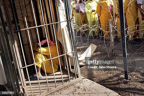 An Iraqi detainee sleeps off his time in a solitary cell, punishment after fighting with another prisoner at the Abu Ghraib Prison October 28, 2005...