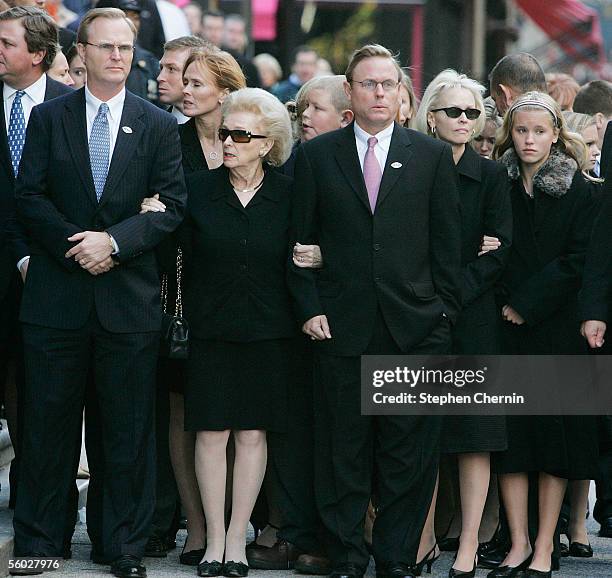 Wellington Mara's widow Ann is flanked by her sons John and Chris as they await the arrival of the casket during the funeral mass for New York Giants...