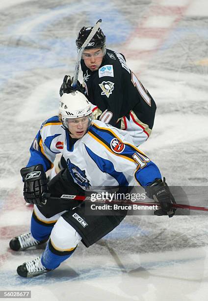 Stephen Dixon of the Wilkes-Barre/Scranton Penguins pursues the play with Sean Bergenheim of the Bridgeport Sound Tigers at Bridgeport's Arena at...