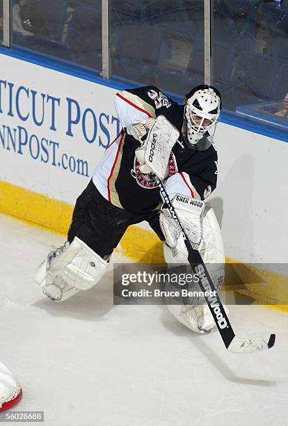 Goaltender Dany Sabourin of the Wilkes-Barre/Scranton Penguins plays the puck behind the net against the Bridgeport Sound Tigers at Bridgeport's...