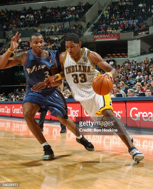 Danny Granger of the Indiana Pacers drives against Caron Butler of the Washington Wizards October 28, 2005 at Conseco Fieldhouse in Indianapolis,...