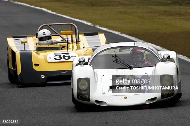 Japanese racing driver Seiji Ara drives his 1966 Porsche 906 Carrera 6 to lead 1971 Chevron B19 during the round one race of class 3 and 4 in the Le...