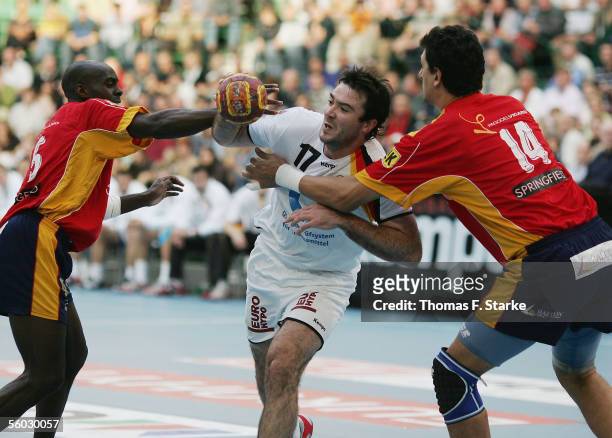 Andrej Klimovets of Germany battles for the ball with David Davis Camara and Juan Perez Marquez of Spain during the handball QS Supercup match...