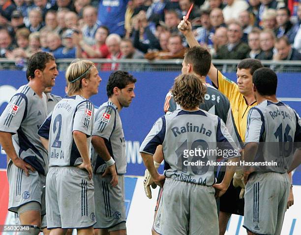 Christian Poulsen of Schalke gets the red card from referee Herbert Fandel during the Bundesliga match between Hamburger SV and Schalke 04 at the AOL...