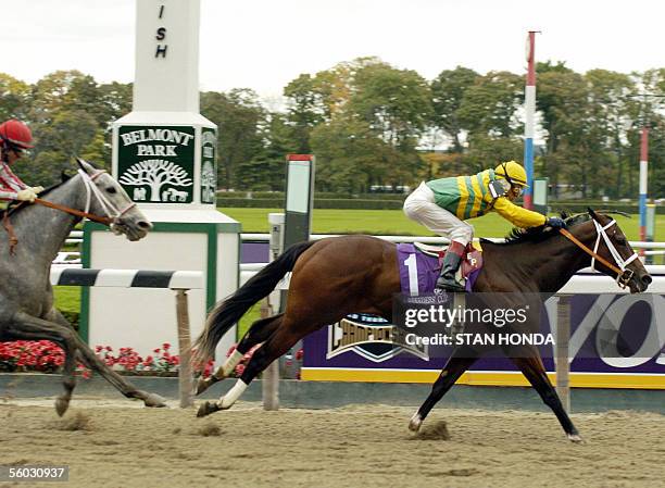 Elmont, UNITED STATES: Folklore , ridden by jockey Edgar Prado, wins the Breeders' Cup Juvenile Fillies championship over Wild Fit with jockey Alex...