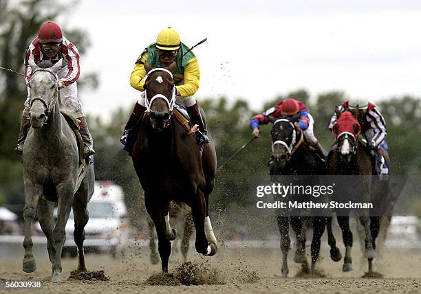 Winner, Folklore, ridden by Edgar Prado , races against Wild Fit ridden by Alex Solis in the Alberto VO5 Breeders' Cup Juvenile Fillies race during...