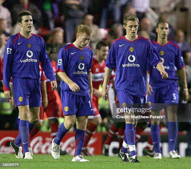 John O'Shea, Paul Scholes and Darren Fletcher of Manchester United look disappointed while walking off at half-time during the Barclays Premiership...