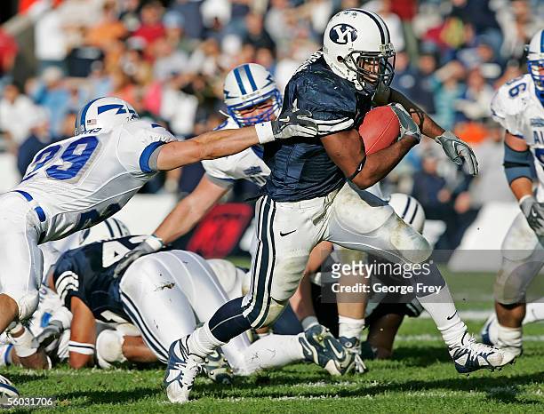 Curtis Brown of the Brigham Young University Cougars runs past Chris Huckins of Air Force Falcons during the fourth quarter October 29, 2005 in...