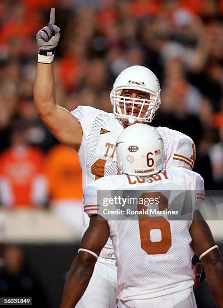 Tight end David Thomas of the Texas Longhorns celebrates a touchdown with teammate Quan Cosby against the Oklahoma State Cowboys October 29, 2005 at...