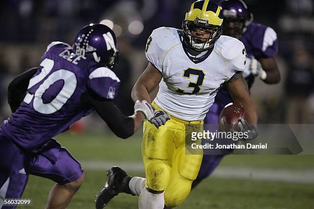 Running back Kevin Grady of the Michigan Wolverines rushes with the ball against Marquice Cole of the Northwestern Wildcats on October 29, 2005 at...