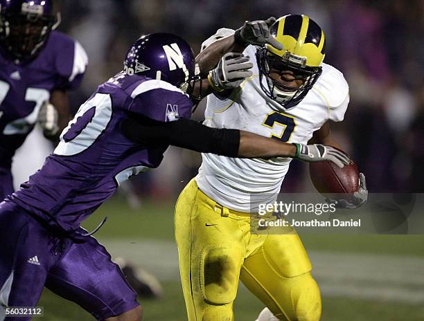 Running back Kevin Grady of the Michigan Wolverines rushes with the ball against Marquice Cole of the Northwestern Wildcats on October 29, 2005 at...