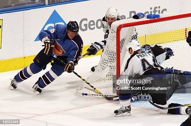 Marian Hossa of the Atlanta Thrashers tries to score past Nolan Pratt and goalie John Grahame of the Tampa Bay Lightning October 29, 2005 at Philips...