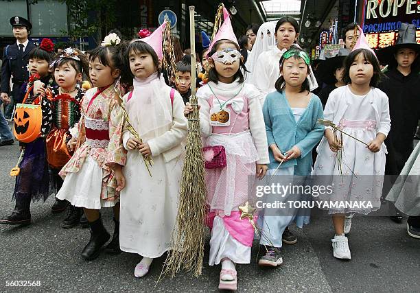 Children wearing costumes march on a shopping mall during the Halloween Parade in Kawasaki, suburban Tokyo, 30 October 2005. More than 3,000 people...