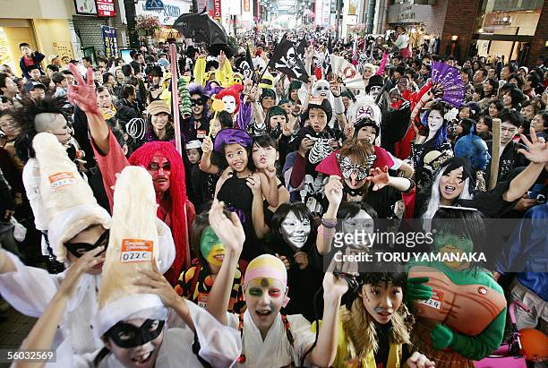 People clad in special costumes march on a shopping mall during the Halloween Parade in Kawasaki, suburban Tokyo, 30 October 2005. More than 3,000...