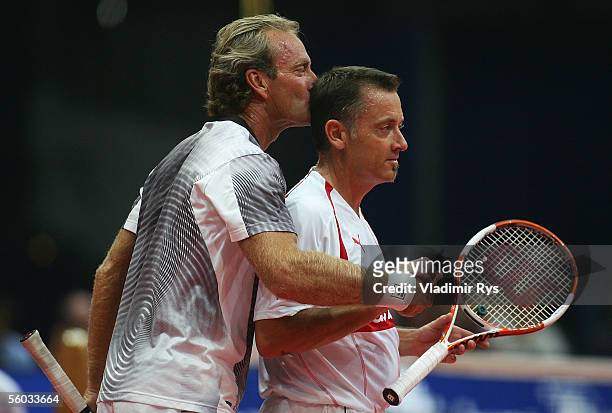 Peter McNamara of Australia kisses his partner Mikael Pernfors of Sweden after hiting him a ball at his head during the Deichmann Champions Trophy at...