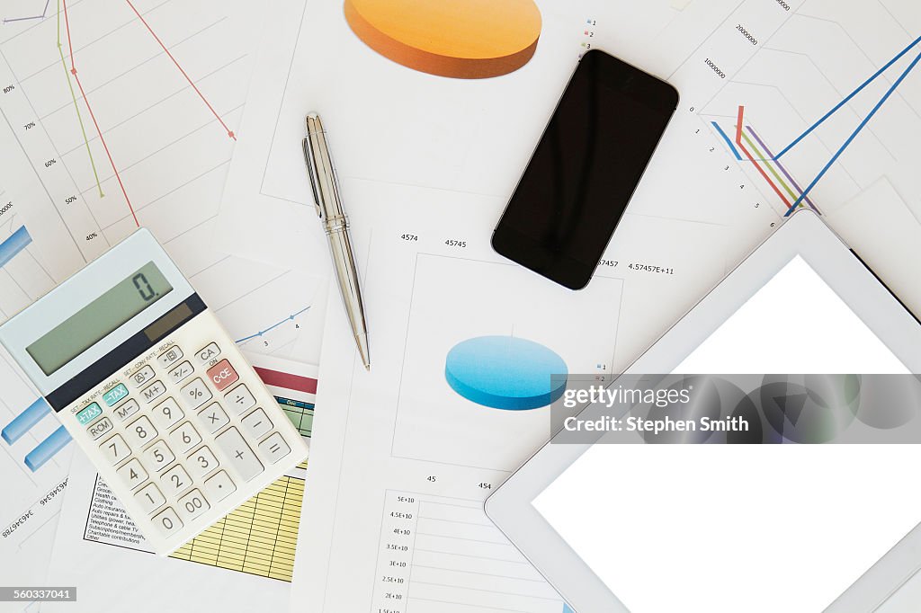 Digital tablet, mobile, calculator and paperwork