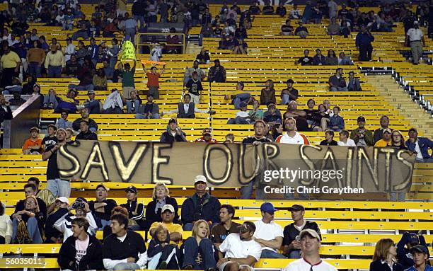 New Orleans Saints fans hold up a sign which reads "Save our Saints" during the Miami Dolphins game on October 30, 2005 at Tiger Stadium on the...