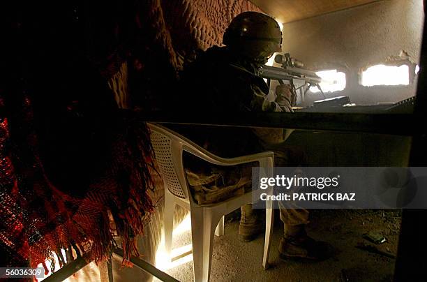 Marine sniper fires at insurgents with a 50mm caliber gun from a hideout on a rooftop near the town of al-Qaim at the Iraqi-Syrian border, in western...