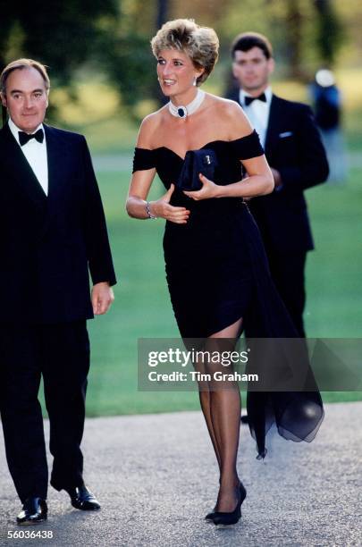 Lord Palumbo greets Princess Diana, wearing a short black cocktail dress designed by Christina Stambolian, as she atttends a Gala at the Serpentine...