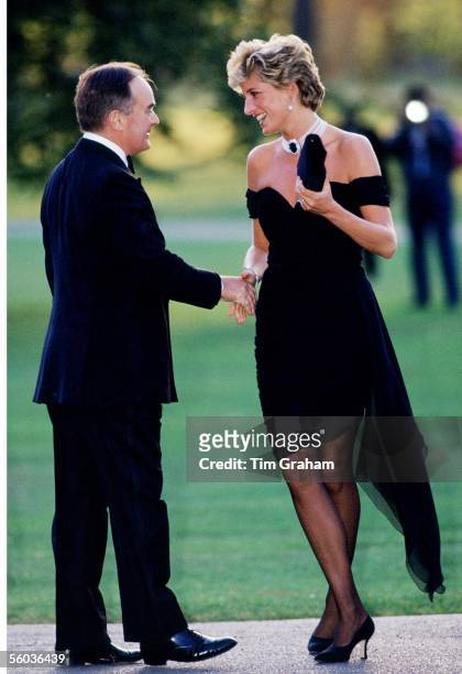 Lord Palumbo greets Princess Diana, wearing a short black cocktail dress designed by Christina Stambolian, as she atttends a Gala at the Serpentine...