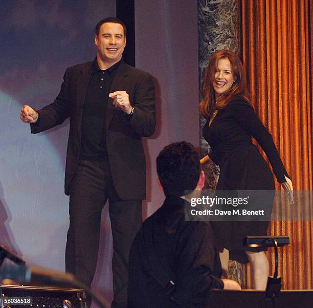 Actors John Travolta and his wife Kelly Preston dance on stage at the Church of Scientology Annual Gala charity concert headed by Isaac Hayes, at...