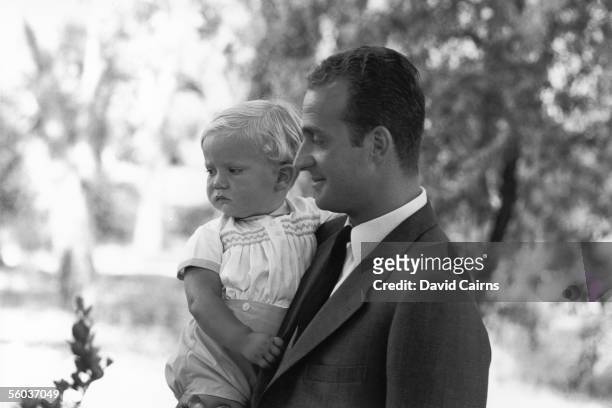 Prince Juan Carlos, future King of Spain, holding his son Prince Felipe in Madrid, 28th July 1969.
