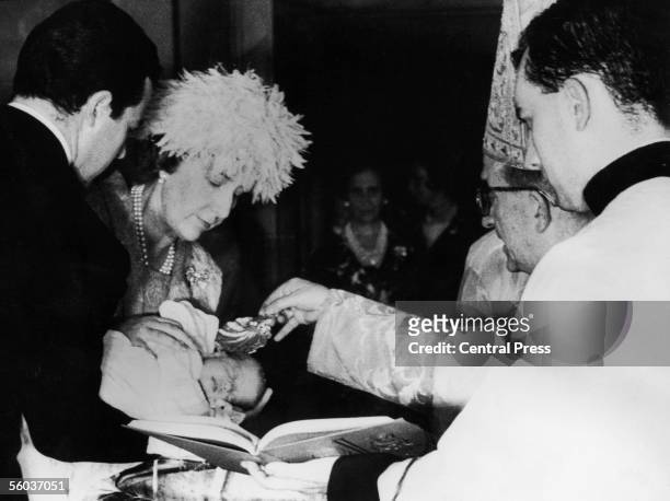 Godparents Dona Cristina and Don Alfonso de Borbon, Duke of Cadiz, holding Princess Cristina during her christening at the Palace of Zarzuela near...