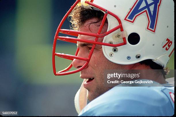 Defensive lineman Ray Childress of the Houston Oilers appears to have a tear running down his cheek while on the sideline during a game against the...