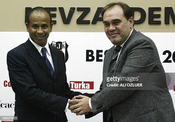 Former Fulham manager Frenchman Jean Tigana shakes hands with Besiktas's Chairman Yildirim Demiroren at a press briefing atfer signing up as manager...