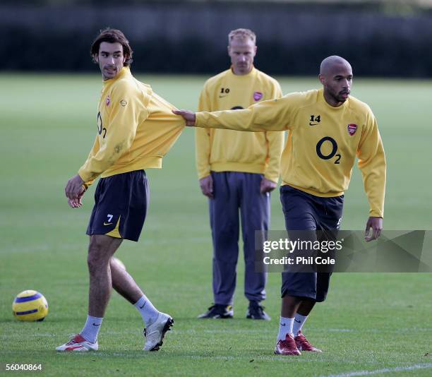 Thierry Henry pulls at Robert Pires' top during Arsenal's training before their Champion League match against Sparta Prague on November 1, 2005 at...