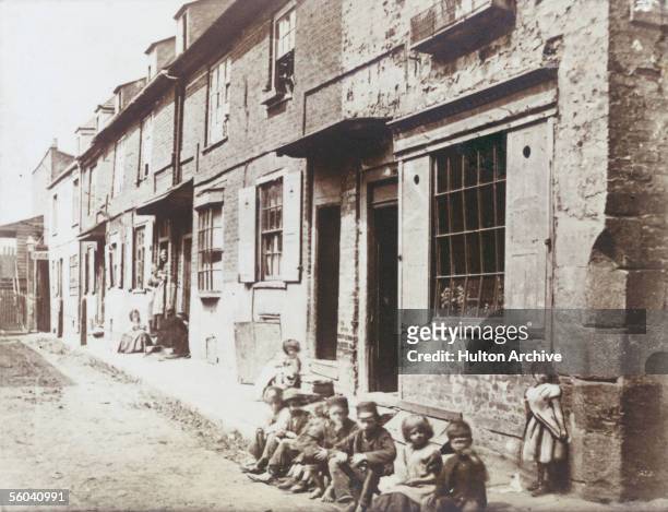 Children sitting on the pavement in New Street, Vauxhall, circa 1860.