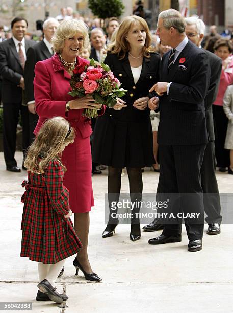 New York, UNITED STATES: Camilla, Duchess of Cornwall, gets flowers from five-year-old Katherine Beaumont as she and her husband Britain's Prince...