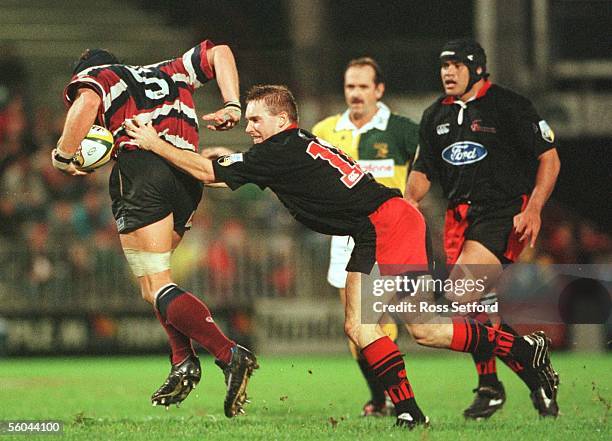 Crusaders Andrew Mehrtens attempts to stop Reds Mark Connors in the Super 12 semi final at Ballymore, Brisbane, Saturday. The Crusaders won 2822.